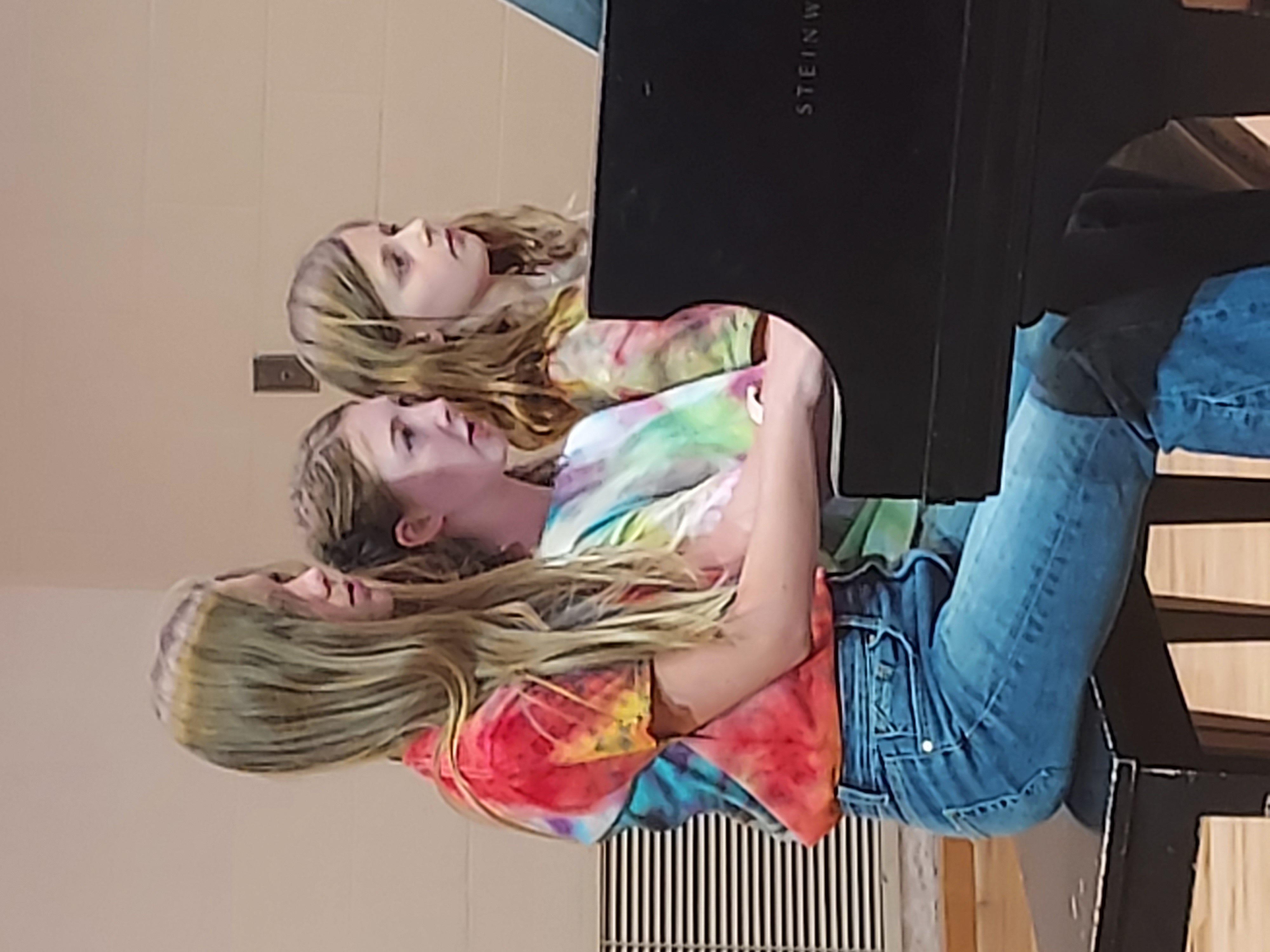 Picture of three girls performing a trio on the piano